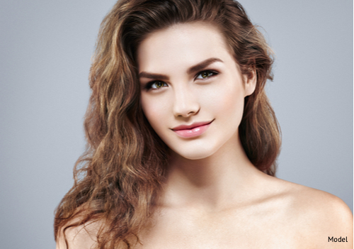 Beautiful woman face close up portrait after facial implants