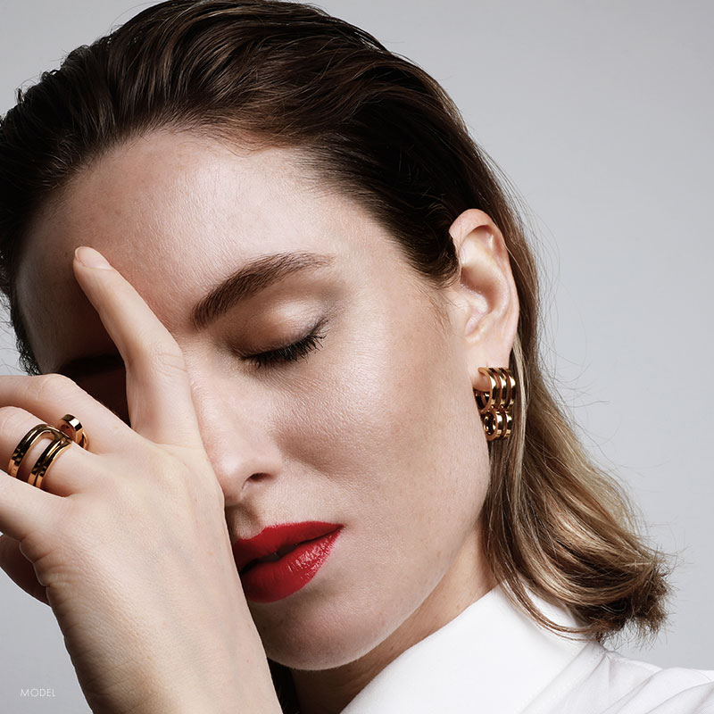 woman with hand on forehead