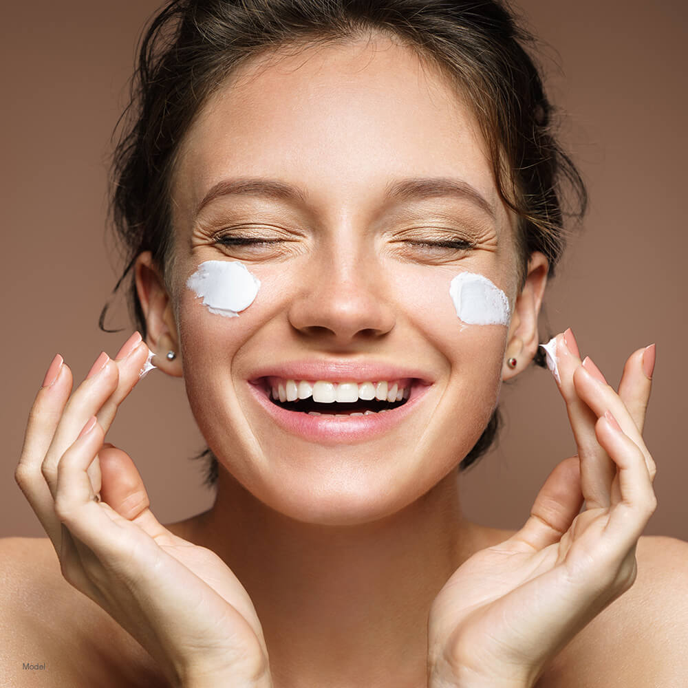 Woman with lotion on face