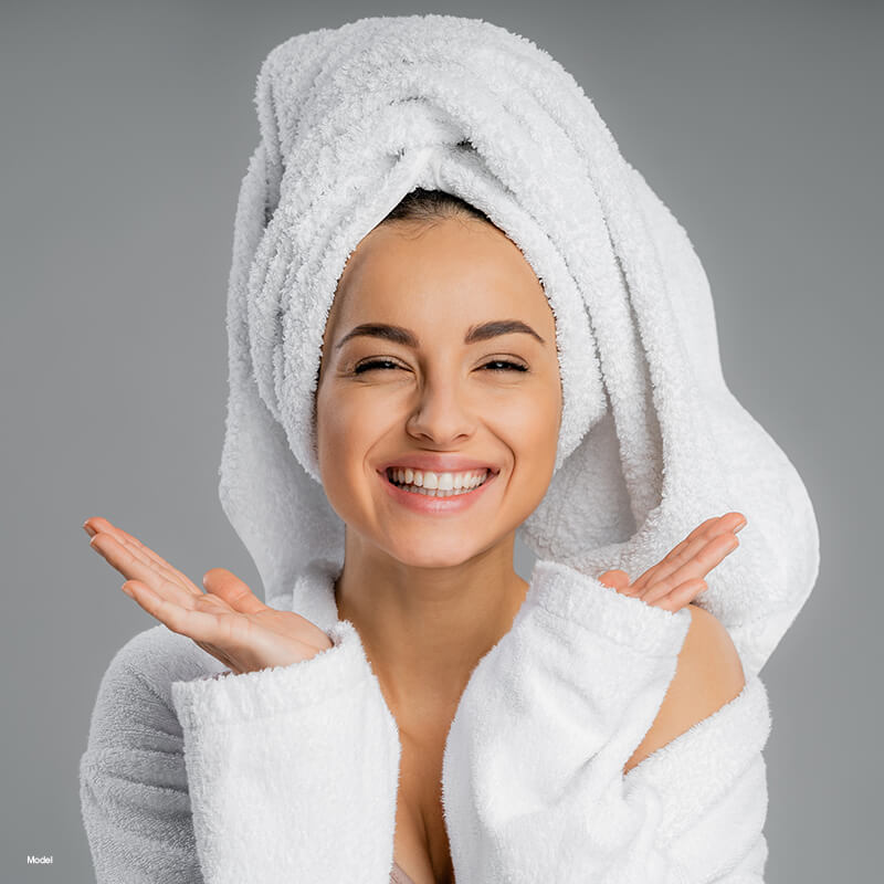 Woman in a white robe and towel
