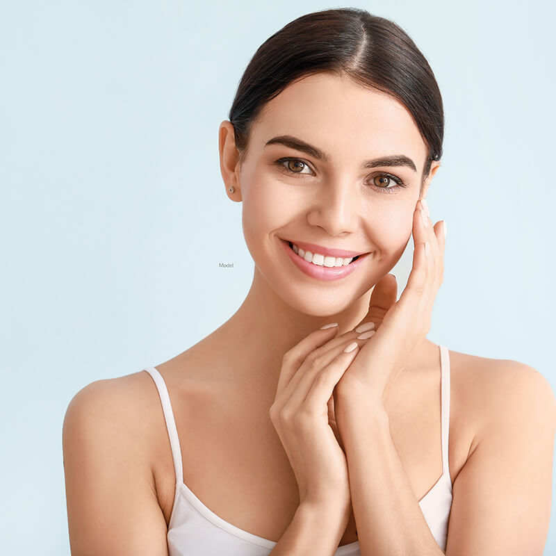 Young woman touching her face