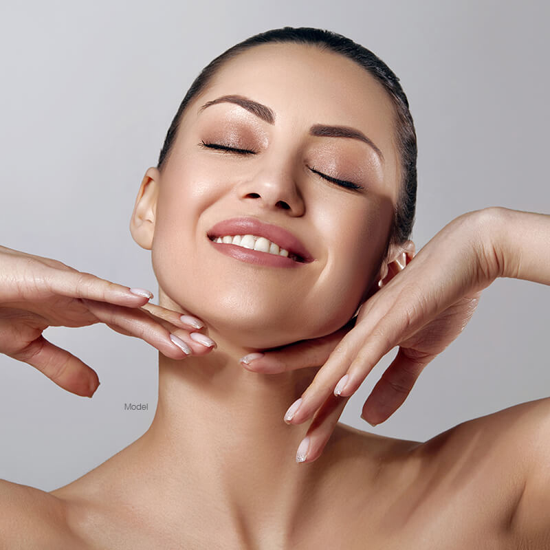 Woman with her arms raised touching her face