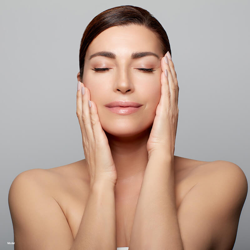 Mature woman touching her face