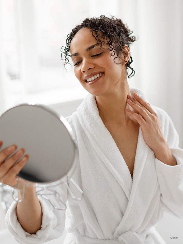 Woman looking at herself in the mirror