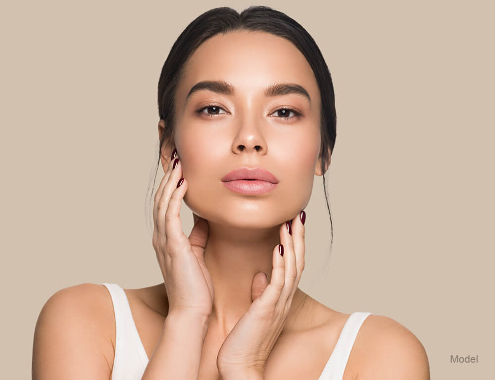 woman touching her face