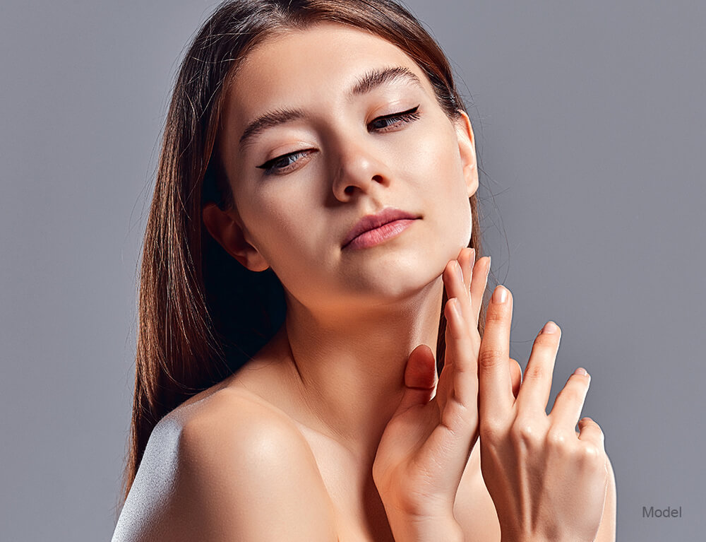 woman touching her chin