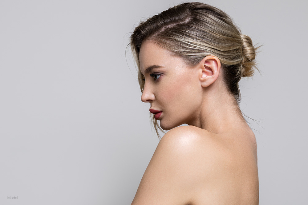 Profile of a young woman wearing a strapless shirt