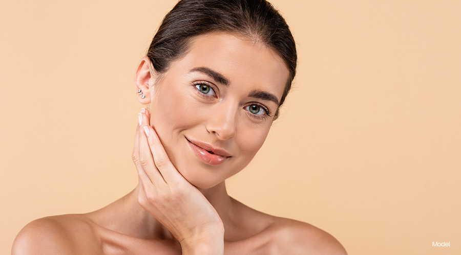 Mature woman against a tan background