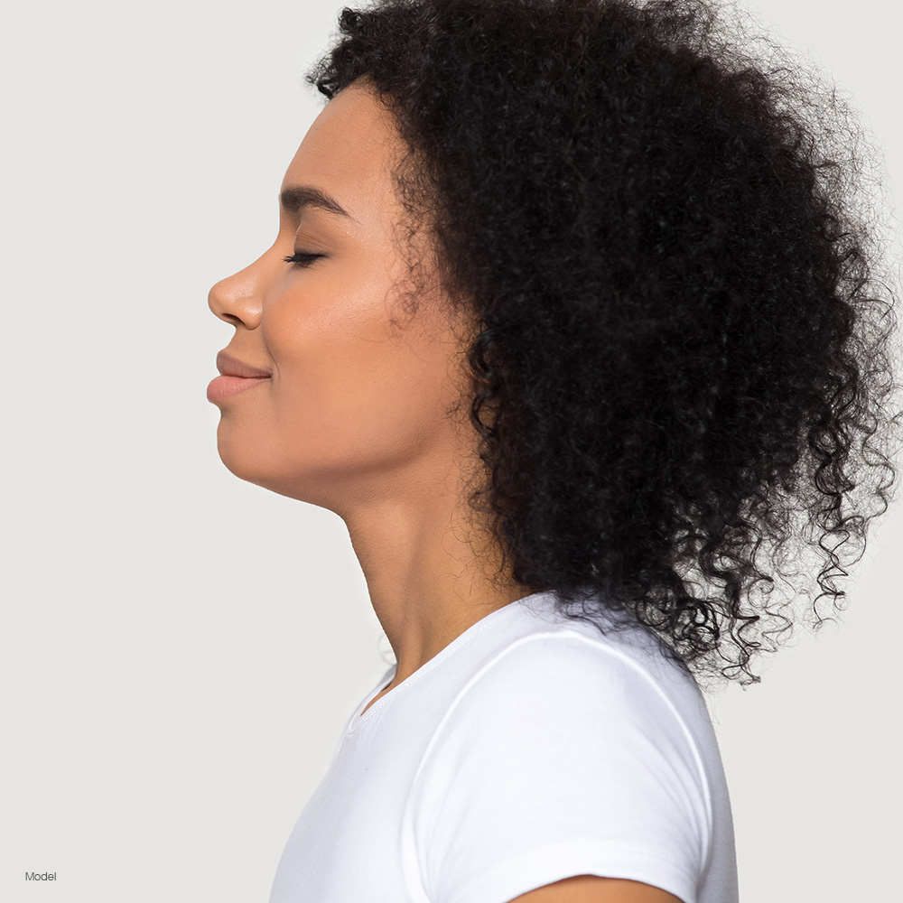 Profile of a woman with curly hair in a white shirt