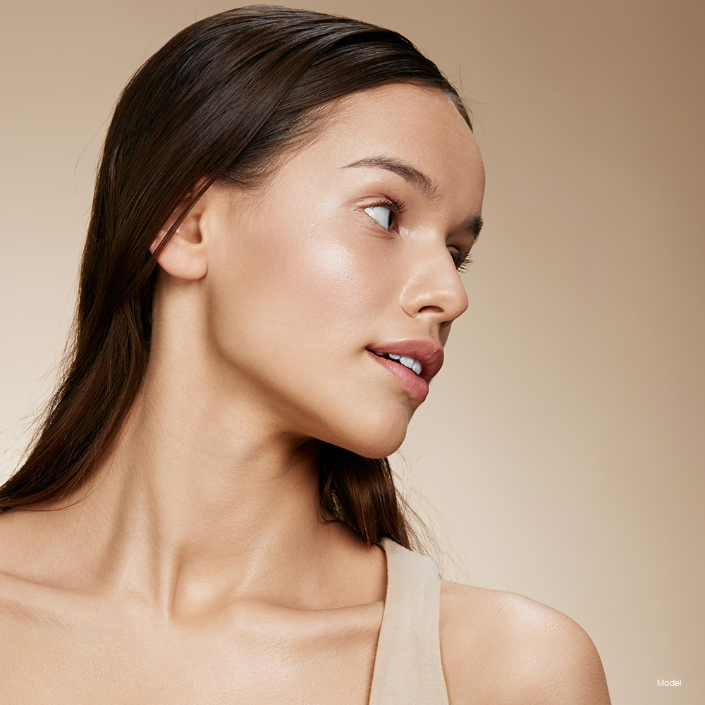 Profile of a young woman in a tan shirt