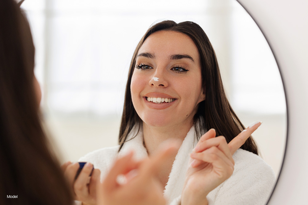 a woman looking at herself in the mirror